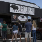 Customers standing in line to place order at Deviled Pig restaurant