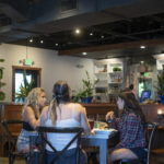 Three young woman sitting at table in restaurant