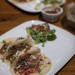 Plate of three tacos and a salad