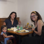 Two woman and child sitting at table in restaurant