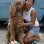 Woman and dog posing with bouquet