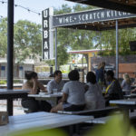 Group of customers sitting at outdoor dining table