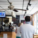 Customers waiting in line to place food order at restaurant