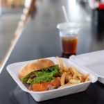 Burger and fries in to-go food container