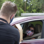 Woman receiving to-go food order in car