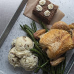 Turkey, green beans, mashed potatoes and cake on restaurant tray