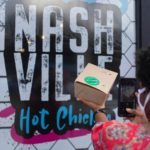 To-go food container with sign that states "Nashville hot chicken"