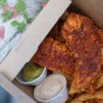 Chicken tenders and french fries in to-go food container