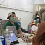 Restaurant employee checking out customer and handing them food