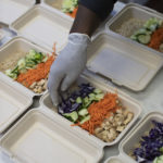 To-go containers with meat and vegetables inside