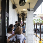 Line of customers waiting to get in restaurant