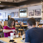 Woman and man sitting at BBQ restaurant table