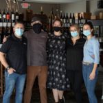 Group of wine shop customers posing for camera