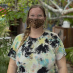 Woman in mask smiling for camera