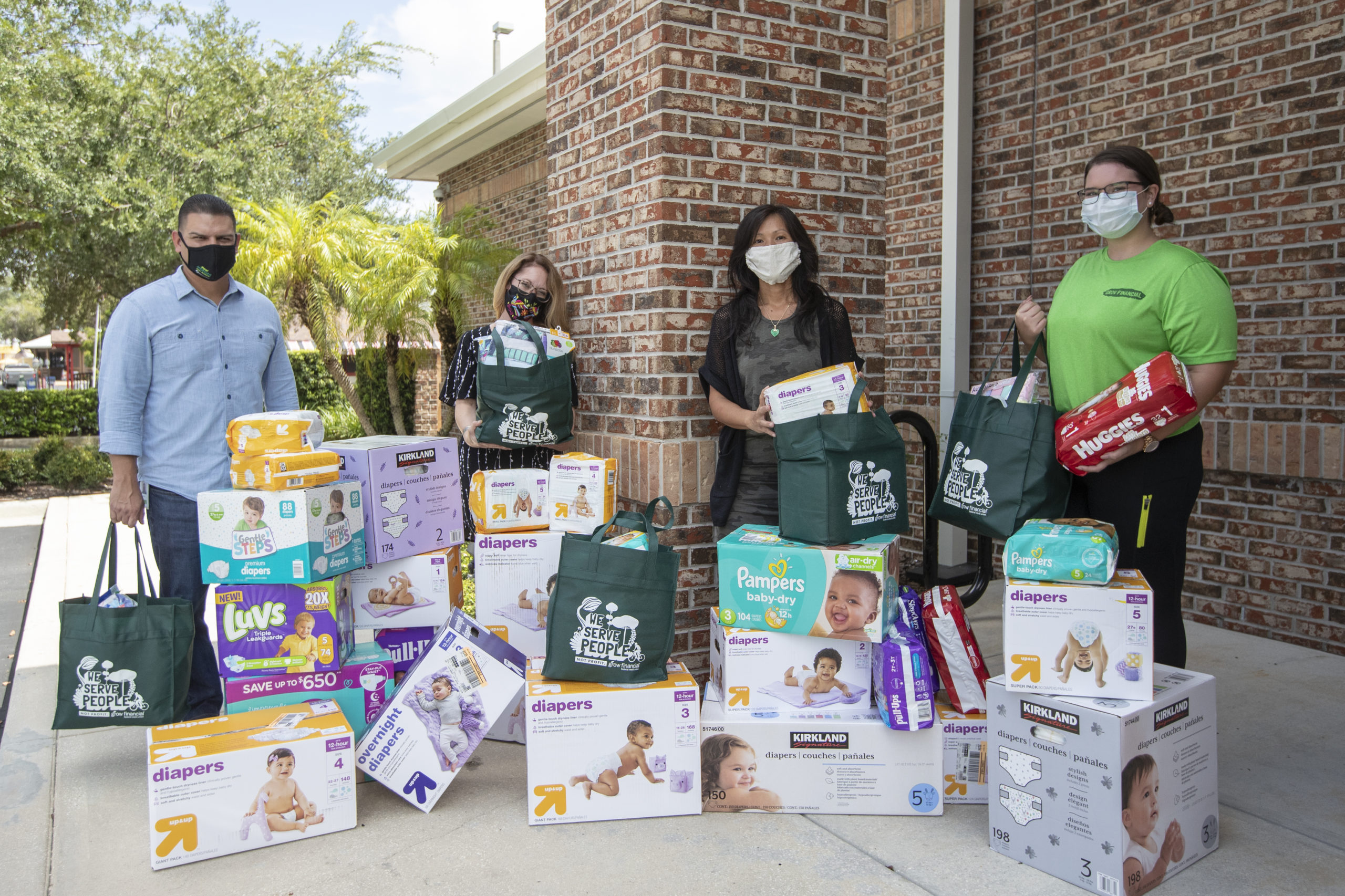 Grow Financial Foundation board members pose with donated necessities for back to school