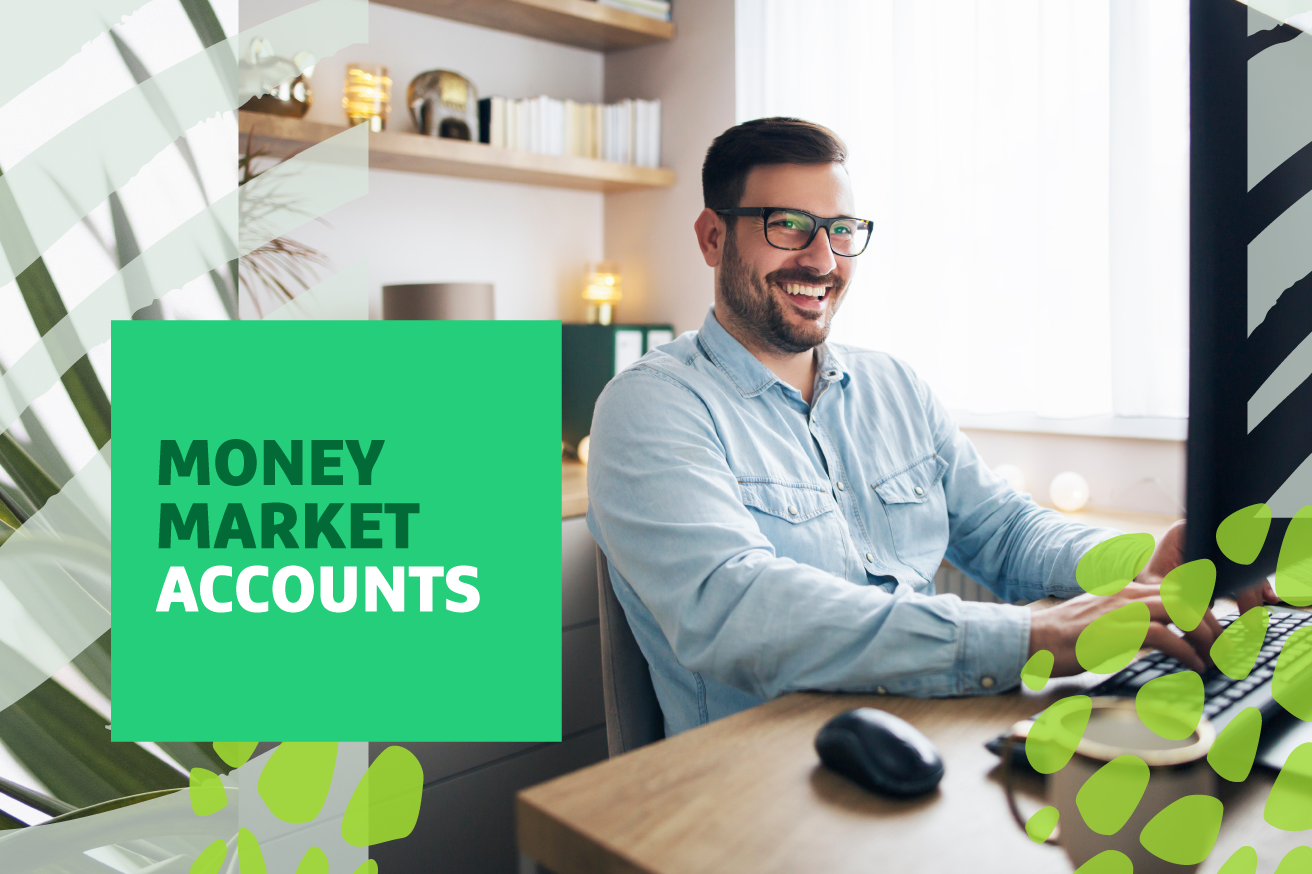 Man working at a desk, smiling at the camera with "Money Market Accounts" text overlayed