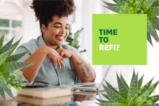 Woman sitting at a laptop smiling with "Time to Refi?" text overlayed