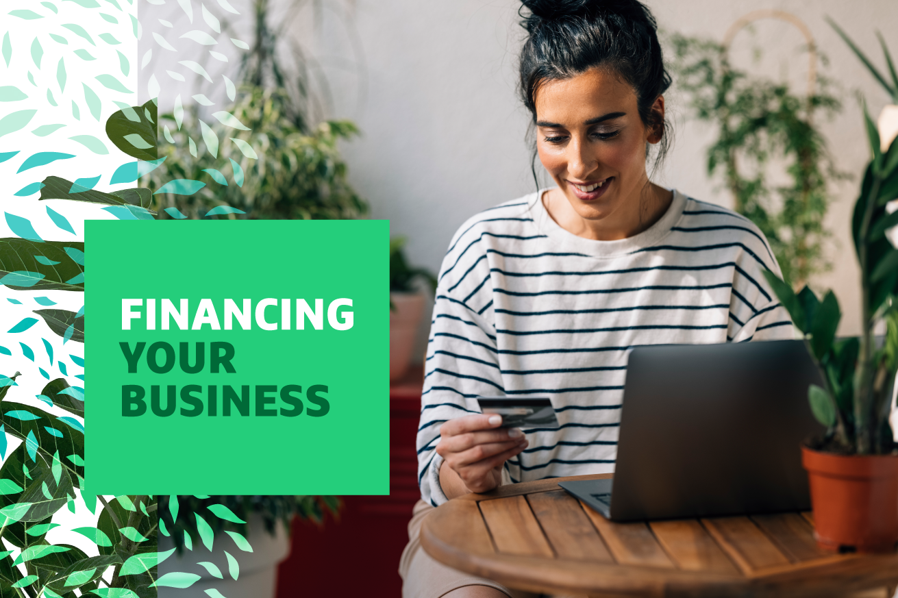 "Financing Your Business" text over image of a woman sitting at a laptop holding a credit card