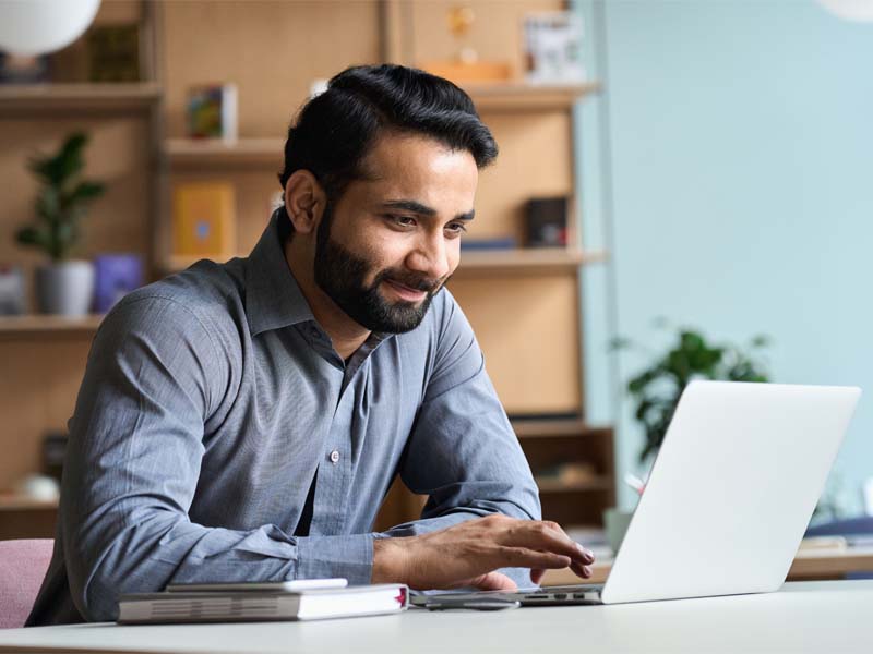 Man sitting at desk on laptop