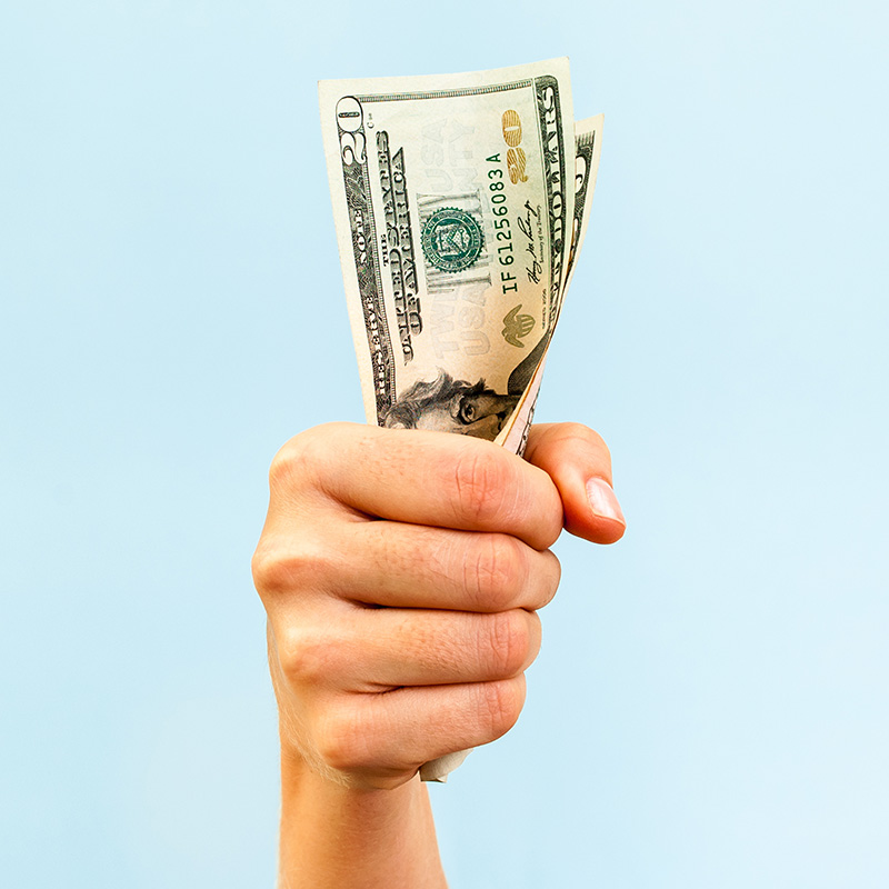 Hand holding $20 bill