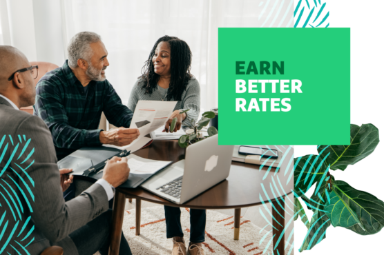 Couple sitting at a table with financial paperwork discussing options with advisor with headline "Earn Better Rates" overlaid.