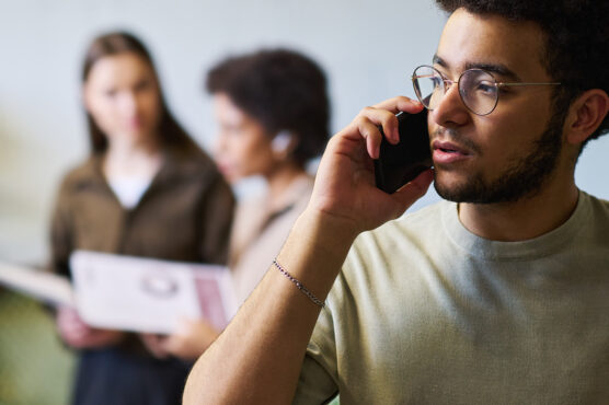 Close-up of a concerned man on a phone call checking for a scam